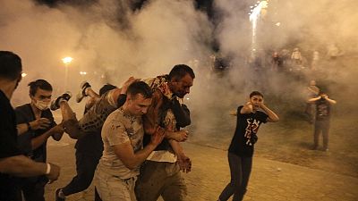 Protesters carry a wounded man during clashes with police after the presidential election in Minsk, Belarus. Protesters carry a wounded man during clashes with police after the presidential election in Minsk, Belarus.
