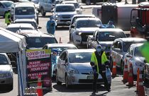 Cars queue at a COVID-19 test centre in Auckland, New Zealand