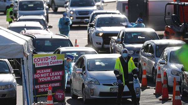 Cars queue at a COVID-19 test centre in Auckland, New Zealand Cars queue at a COVID-19 test centre in Auckland, New Zealand