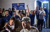 People detained during recent rallies of opposition supporters leave the Okrestina prison early morning in Minsk on August 14, 2020.