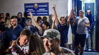 People detained during recent rallies of opposition supporters leave the Okrestina prison early morning in Minsk on August 14, 2020.