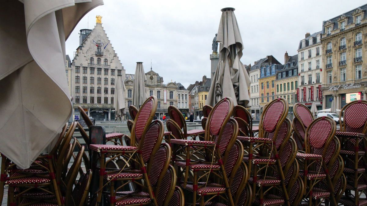 Chairs are stacked up outside an empty restaurant in the center of Lille, northern France