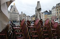 Chairs are stacked up outside an empty restaurant in the center of Lille, northern France