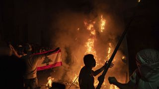 Anti-government protesters burn a barricade near the Parliament building, August 11