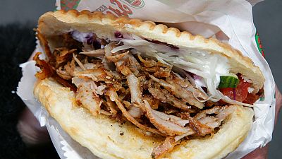 traditional seasoned Doner meat fills a flat bread together with the usual salad, mayonnaise and chilli, at a kebab restaurant in Hanover, Germany.