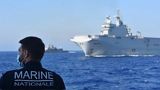 French Tonnerre helicopter carrier escorted by Greek and French military vessels during a maritime exercise in the Eastern Mediterranean.