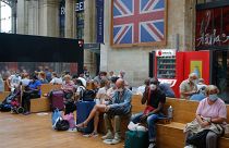 Passengers wait next to the Eurostar Terminal at the Gare du Nord train station in Paris