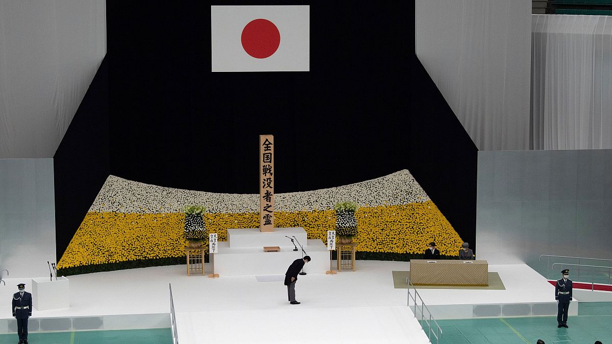 Japanese Prime Minister Abe bows to Emperor Naruhito during the ceremony marking 75 years since WW2