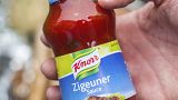 FILE- In this May 6, 2014 taken photo a man holds a bottle of "gypsy sauce" from the manufacturer Knorr in his hand in Berlin, Germany.