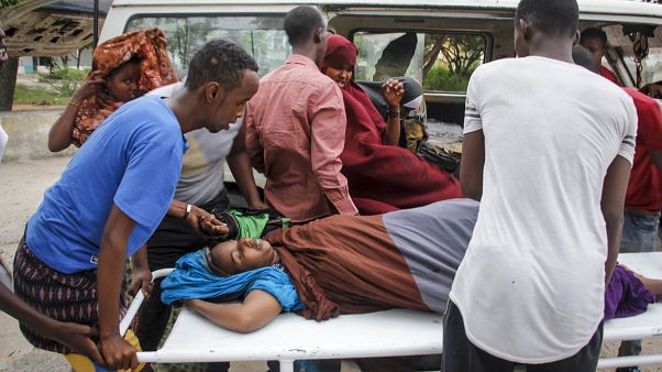 People help a civilian woman, who was wounded when a powerful car bomb blew off the security gates to the Elite Hotel, in Somalia Sunday, Aug. 16, 2020. People help a civilian woman, who was wounded when a powerful car bomb blew off the security gates to the Elite Hotel, in Somalia Sunday, Aug. 16, 2020.