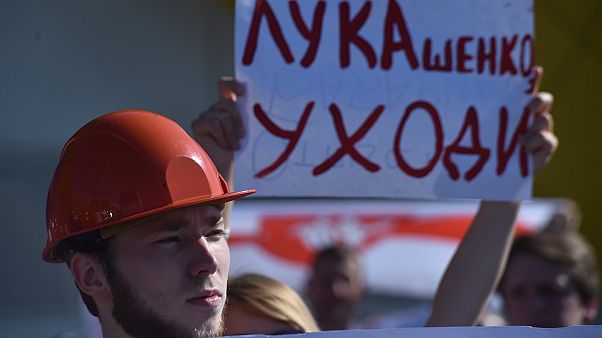 Workers of Minskenergo (Minsk Energy Company) hold a poster reading "Lukashenko go away!" during the rally in Minsk, on August 17, 2020,