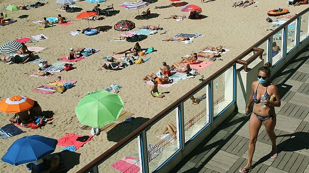 A woman wearing a face mask to protect against coronavirus, near the beach, in Saint Jean de Luz, southwestern France. A woman wearing a face mask to protect against coronavirus, near the beach, in Saint Jean de Luz, southwestern France.