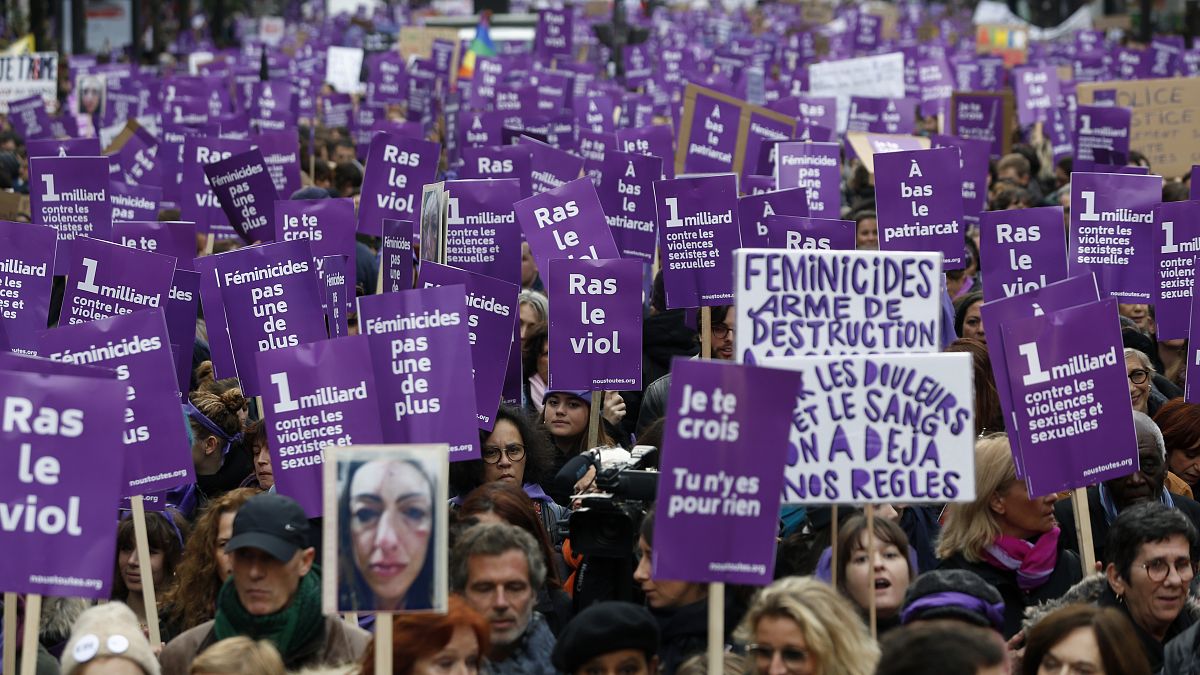 Women hold placards as they march against domestic violence, in Paris, Saturday, Nov, 23, 2019.