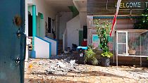 In this photo provided by the Philippine Red Cross, debris are scattered at a house after a quake struck in Cataingan, Masbate province, central Philippines.