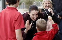 New Zealand Prime Minister Jacinda Ardern gestures with a student during the opening ceremony for Redcliffs School in Christchurch, New Zealand, Thursday, June 25, 2020
