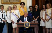 دونالد ترامپ در حال امضای اعلامیه‌ای در گرامیداشت صدمین سالگرد اعطای حق رای به زنان در آمریکا