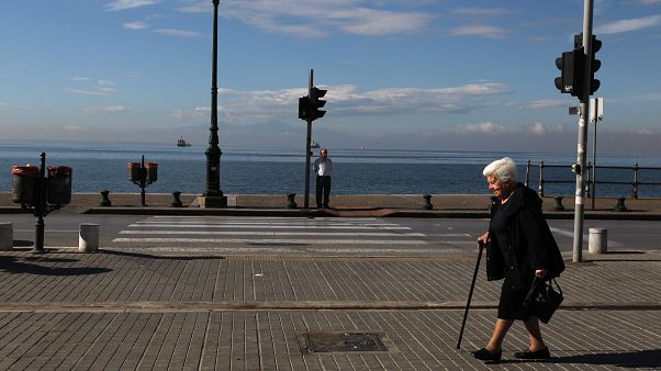 Elderly people walk along a coastal avenue in the northern Greek port city of Thessaloniki. Elderly people walk along a coastal avenue in the northern Greek port city of Thessaloniki.