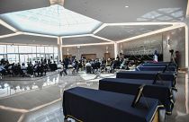The coffins of the six humanitarian aid workers from the French NGO ACTED are seen during a ceremony at Orly Airport, south of Paris, Friday, Aug. 14, 2020.