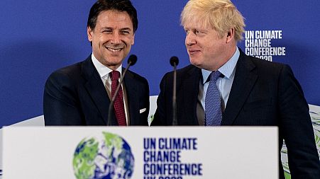 Britain's Prime Minister Boris Johnson (R) and Italy's Prime Minister Giuseppe Conte shakes hands during an event to launch the United Nations' Climate Change conference.