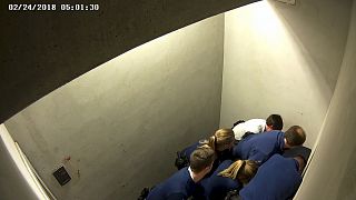 Police officers subdue Slovak man, Jozef Chovanec in this image taken from CCTV inside a cell at Charleroi airport in Belgium.