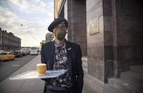 A protester holds a symbolic cup of tea to support Russian opposition leader Alexei Navalny in front of the FSB building  in St. Petersburg, Russia, Thursday, Aug. 20, 2020.