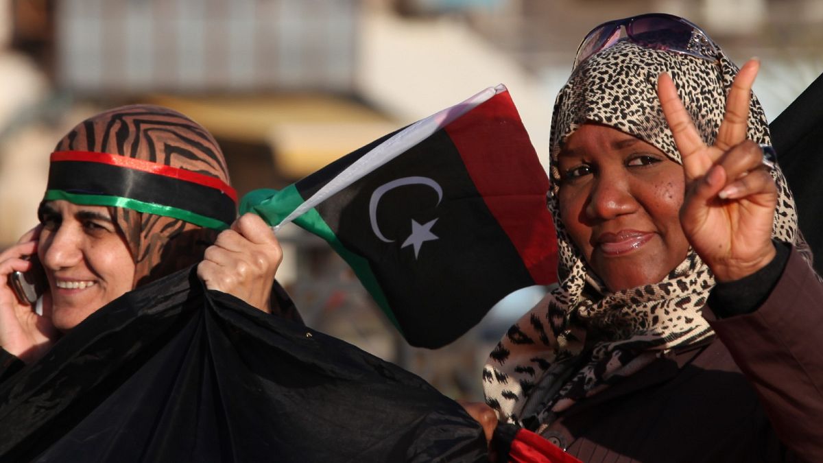 a Libyan woman flashes the victory sign at Tahrir Square, during the second anniversary of the uprising that toppled dictator Moammar Gadhafi in Benghazi, Libya, Feb 17, 2013