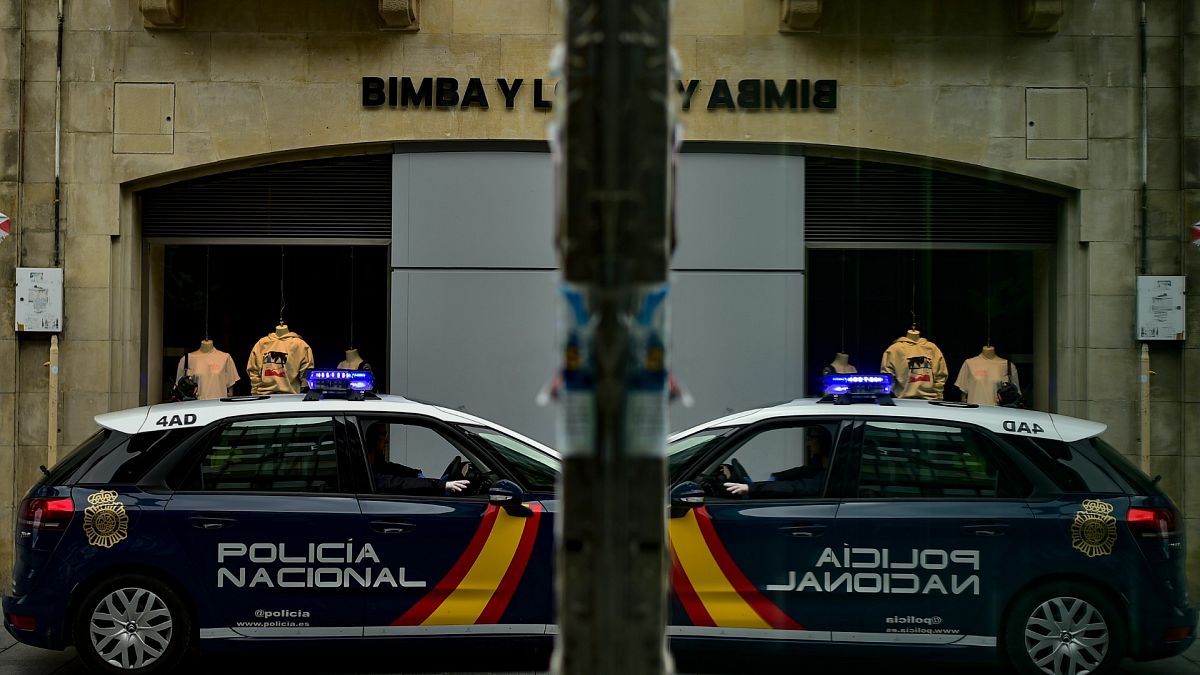 A Spanish police car is reflected in glass during a patrol in Pamplona, northern Spain.