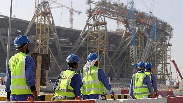 Workers walk to the Lusail Stadium, one of the 2022 World Cup stadiums, in Lusail, Qatar, Friday, Dec. 20, 2019. 