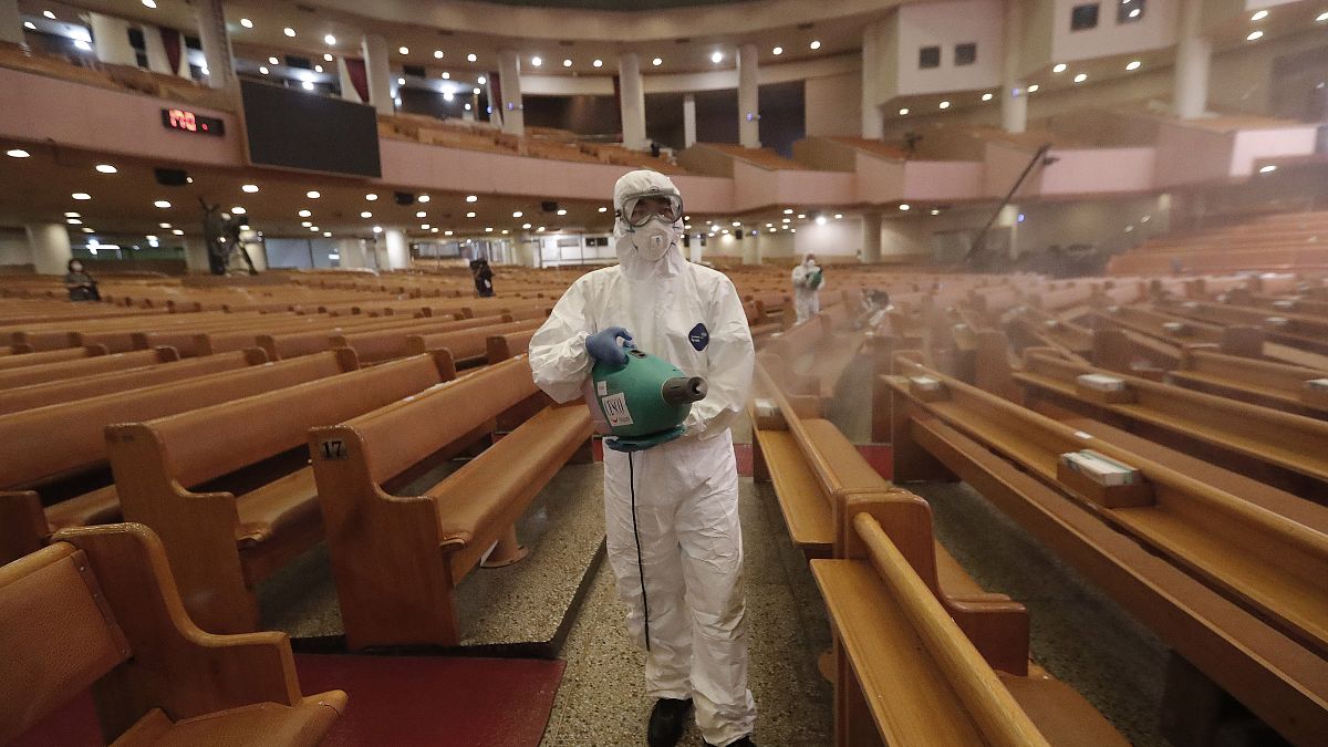 A public official disinfects as a precaution against the coronavirus at the Yoido Full Gospel Church in Seoul, South Korea, Friday, Aug. 21, 2020