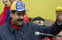 Venezuela's President Nicolas Maduro shows a mango