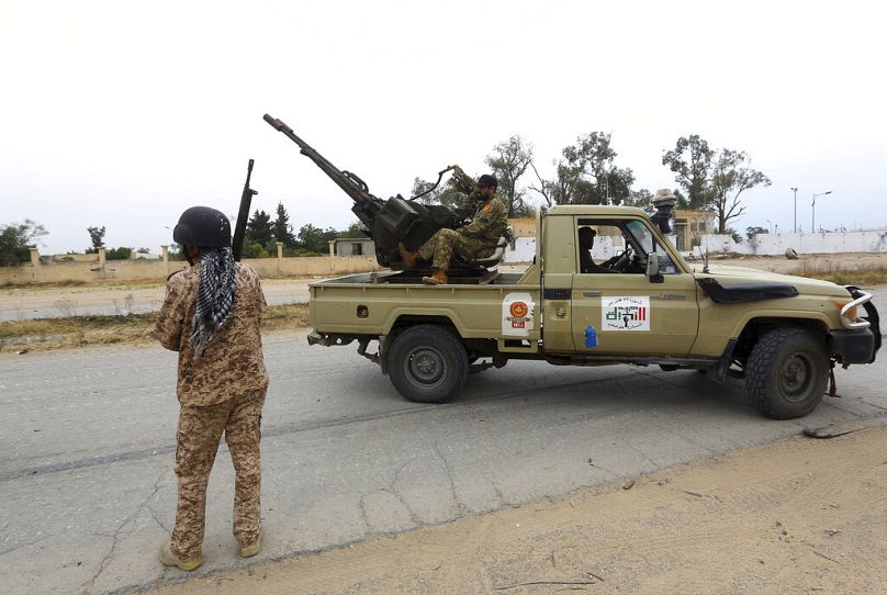FILE: Tripoli government forces look on during clashes with forces led by General Khalifa Haftar south of the capital Tripoli, 21 May 2019