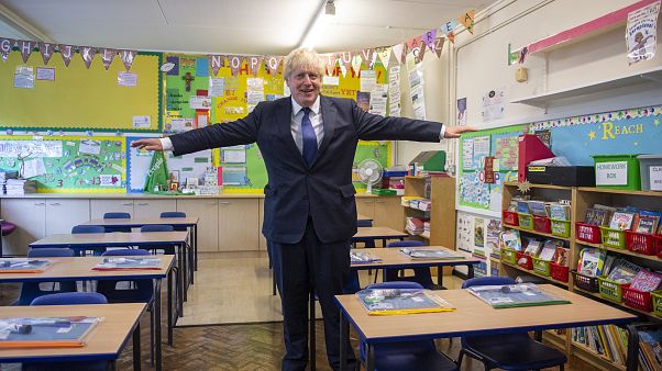 In this Aug. 10, 2020, file photo, Britain's Prime Minister Boris Johnson visits St Joseph's Catholic Primary School, London. In this Aug. 10, 2020, file photo, Britain's Prime Minister Boris Johnson visits St Joseph's Catholic Primary School, London.
