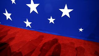 In this July 19, 2016 file photo, the shadow of delegates are seen on the convention floor during the second day of the Republican National Convention in Cleveland.