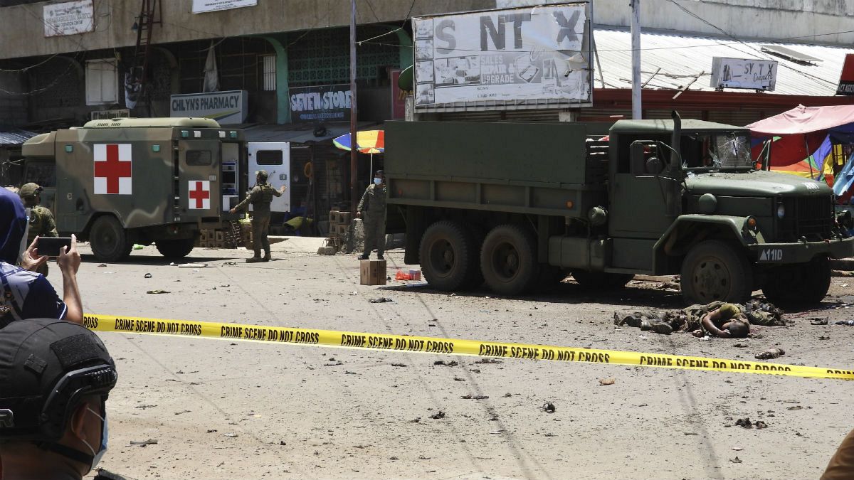 Soldiers recover bodies at the site of an explosion in the town of Jolo, Sulu province, southern Philippines on Monday Aug. 24, 2020. 