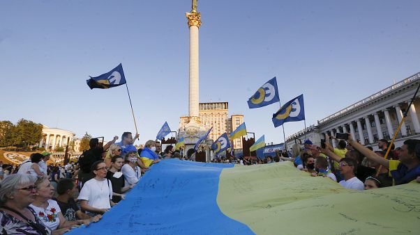 People carry a huge 33 meter-long Ukrainian national flag as they mark the State Flag Day in Kyiv, Ukraine, Sunday, Aug. 23, 2020. People carry a huge 33 meter-long Ukrainian national flag as they mark the State Flag Day in Kyiv, Ukraine, Sunday, Aug. 23, 2020.