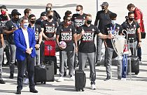 Bavaria Governor Markus Soeder, left, stands with the FC Bayern Munich team after their arrival at Munich Airport, Germany.