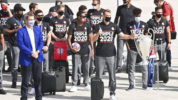 Bavaria Governor Markus Soeder, left, stands with the FC Bayern Munich team after their arrival at Munich Airport, Germany. Bavaria Governor Markus Soeder, left, stands with the FC Bayern Munich team after their arrival at Munich Airport, Germany.