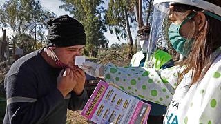 عامل صحي يجري اختبارًا لحاسة الشم  لأحد سكان حي ألتوس دي سان لورينزو، بالقرب من مدينة لا بلاتا، على بعد 65 كم من مدينة بوينس آيرس، الأرجنتين، 24 مايو 2020