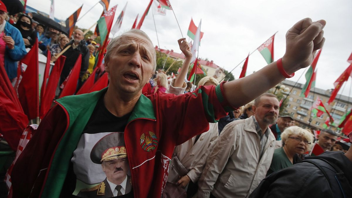 A man wearing a sweatshirt with a portrait of Belarus President Alexander Lukashenko attends a pro-government rally in Minsk.