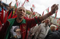 A man wearing a sweatshirt with a portrait of Belarus President Alexander Lukashenko attends a pro-government rally in Minsk.