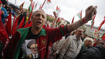A man wearing a sweatshirt with a portrait of Belarus President Alexander Lukashenko attends a pro-government rally in Minsk. A man wearing a sweatshirt with a portrait of Belarus President Alexander Lukashenko attends a pro-government rally in Minsk.