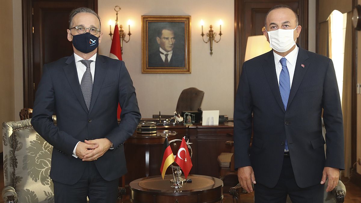 Turkey's Foreign Minister Mevlut Cavusoglu, right, and German counterpart Heiko Maas pose for photos before their talks, in Ankara, Turkey, Tuesday, Aug. 25, 2020.