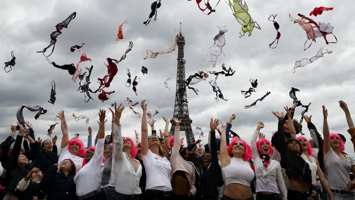 Tens of women throw their bras into the air as part of the annual Pink Bra Toss, in front of the Eiffel Tower, in Paris