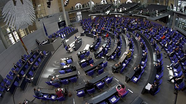 Lawmakers attend a meeting of the German federal parliament, or Bundestag, at the Reichstag building in Berlin. Lawmakers attend a meeting of the German federal parliament, or Bundestag, at the Reichstag building in Berlin.