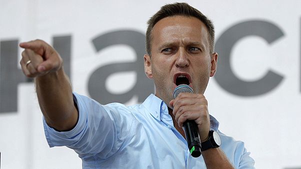 Russian opposition activist Alexei Navalny gestures while speaking to a crowd during a political protest in Moscow. Russian opposition activist Alexei Navalny gestures while speaking to a crowd during a political protest in Moscow.