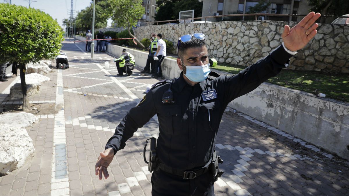 An Israeli police officer works at the site of a stabbing in the Israeli central city of Petah Tikvah, Wednesday, Aug. 26, 2020.
