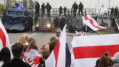 Demonstrators face a roadblock manned by riot police during a protest in Minsk, Belarus.