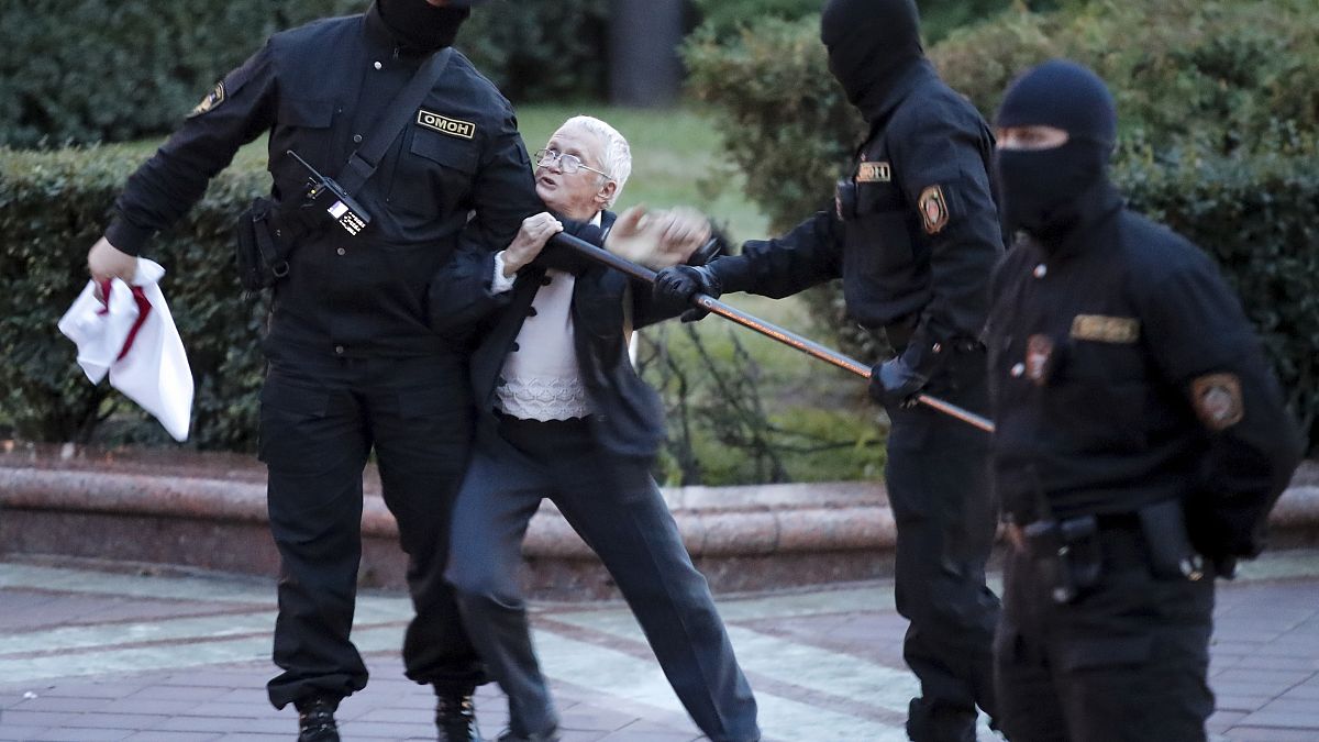 Opposition activist Nina Baginskaya, 73, struggles with police during a Belarusian opposition supporters' rally at Independence Square in Minsk, Belarus, Aug. 26, 2020.