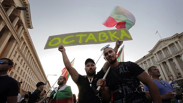 Protesters carry a poster reading "Resignation" during a mass protest in the capital, Sofia. Protesters carry a poster reading "Resignation" during a mass protest in the capital, Sofia.