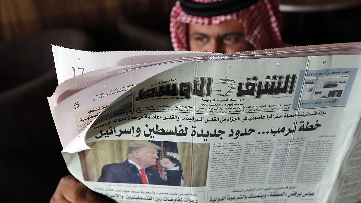 رجل يحمل صحيفة الشرق الأوسط  بمقهى في جدة -المملكة العربية السعودية.